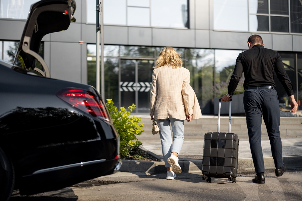 Guests departing Melbourne hotel with luggage using VHA Limos luxury chauffeur transfer