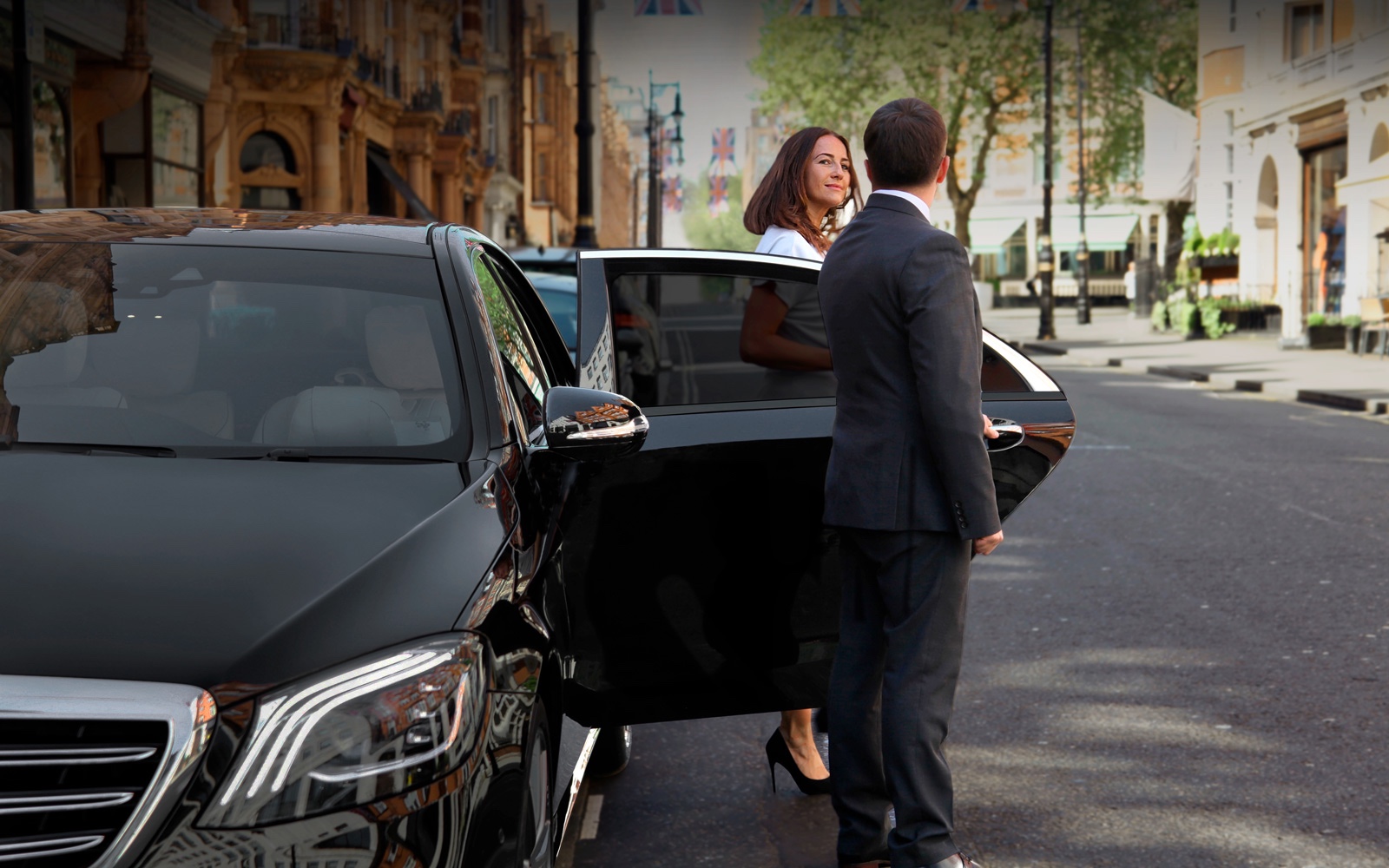Professional chauffeur assisting VIP passenger during discreet celebrity transfer in Melbourne with VHA Limos