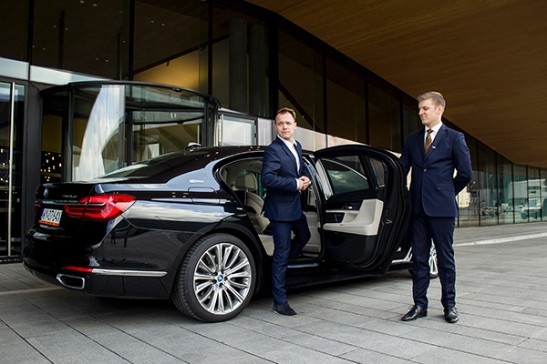 Professional chauffeur assisting passenger during Melbourne airport transfer with VHA Limos